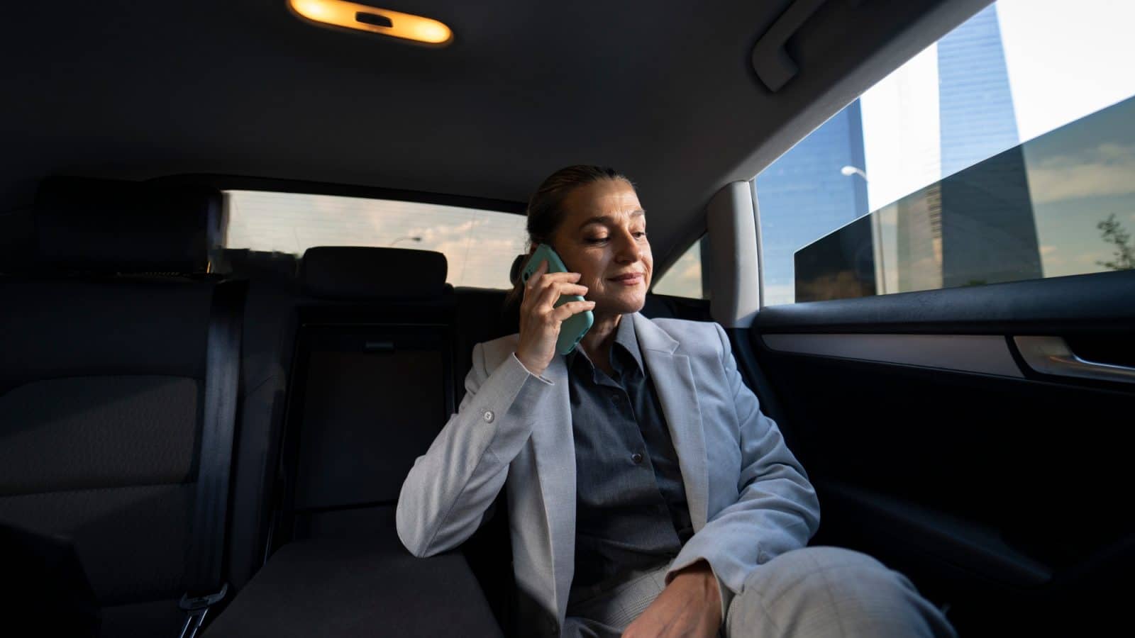 Cheerful woman senior riding car as passenger